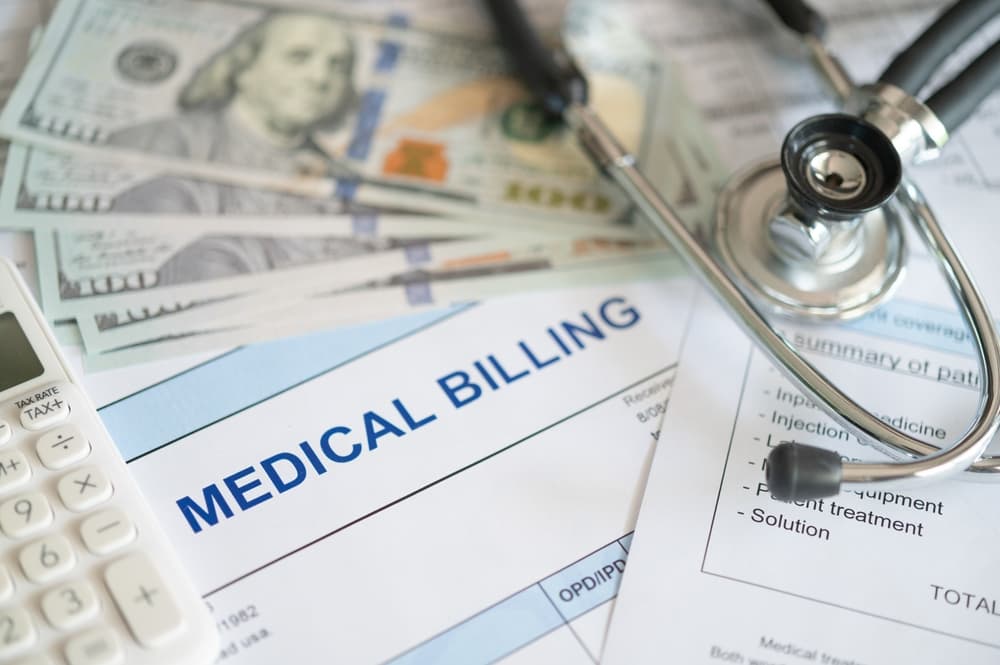 Medical billing document and dollar banknote, calculator, stethoscope. medical treatment expense