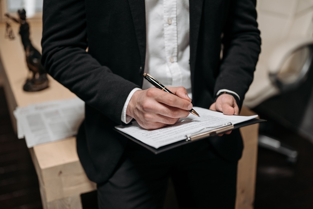 lawyer reviewing documents about how long does a car accident settlement take